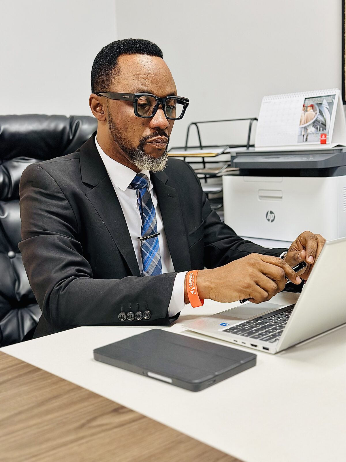 Samuel Ato Afful working on a laptop