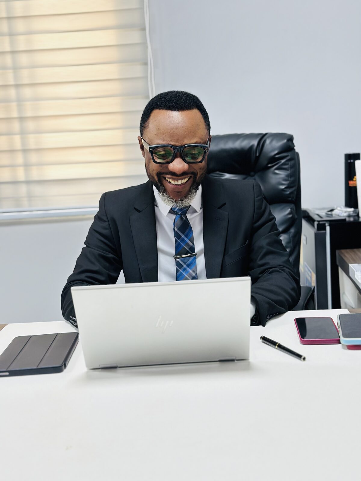 Samuel Ato Afful smiling at his desk